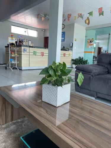 a living room with a couch and a table at Pousada Alvorada in Ubajara
