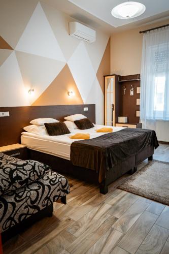 a large bedroom with two beds in a room at Oázis Panzió in Makó
