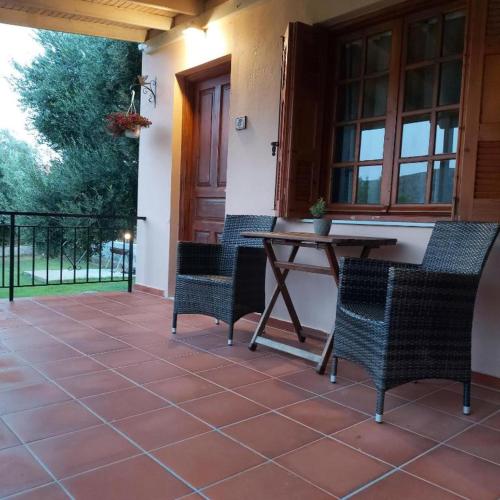 a patio with a table and chairs on a porch at Elia Limnos in Plati