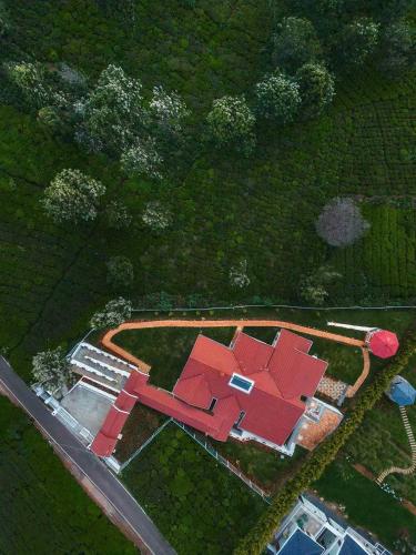 an overhead view of a building with red roof at LohonoStays Villa Lansdowne in Coonoor
