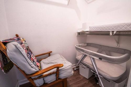a small room with a bed and a chair at Spacious Cozy Home w Gym & Pool, Kid Friendly in Pflugerville