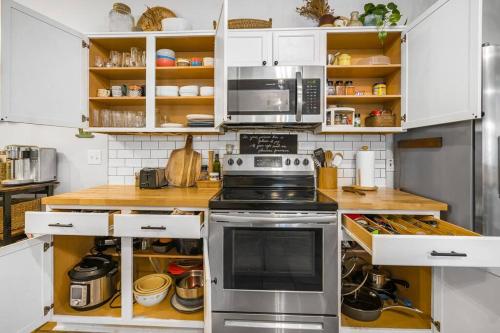 a kitchen with white cabinets and a stove at Spacious Cozy Home w Gym & Pool, Kid Friendly in Pflugerville