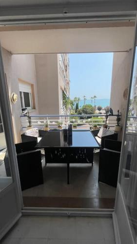 une vue d'un balcon avec une table et des chaises dans l'établissement face à la mer, à Cros-de-Cagnes