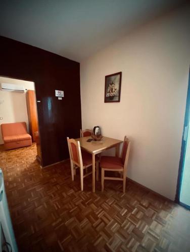 a room with a table and chairs in a room at Apartments Dunja in Sveti Stefan