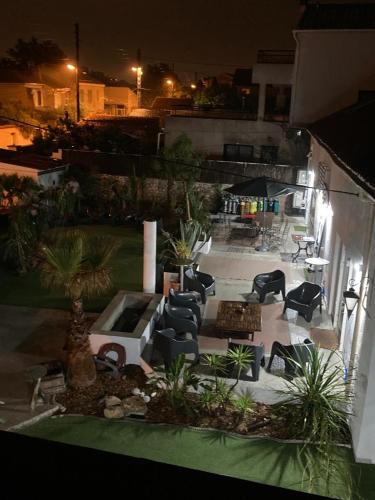 a patio with chairs and tables in a yard at night at MGH Massilia Green House in Marseille