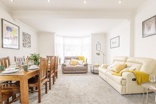 a living room with a couch and a table at Luxury 4 Bedroom Apartment Southsea - Free Parking in Portsmouth