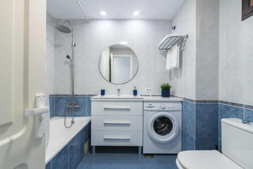 a bathroom with a washing machine in a sink at Paradise Playa del Cura in Las Palmas de Gran Canaria