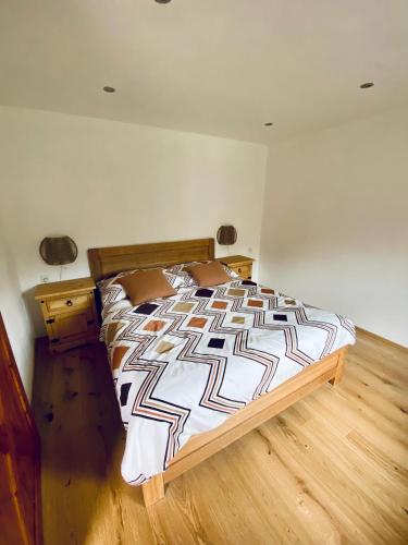 a bedroom with a bed and a wooden floor at Chalupa na Horce in Blata