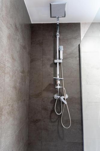 a shower with a shower head in a bathroom at Les Gubies in Beceite