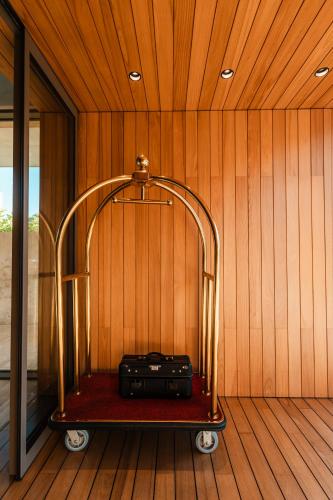 a suitcase sitting on a stand in a room at M Boutique Hotel - Designed for Adults in Paphos City