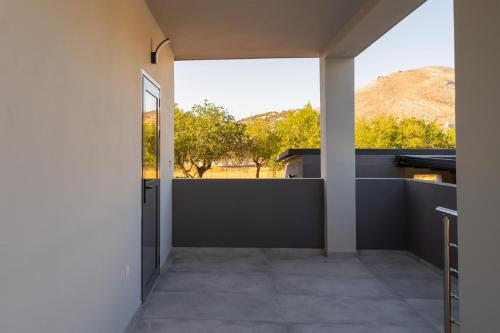 a view from the hallway of a house with a large window at Mezcal Private Pool Villa in Kalívia Thorikoú