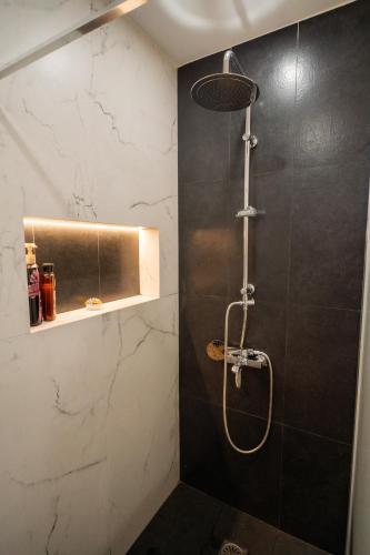 a bathroom with a shower with a shower head at Mezcal Private Pool Villa in Kalívia Thorikoú