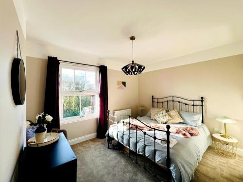 a bedroom with a bed and a window at NEW homely countryside escape in Manningtree