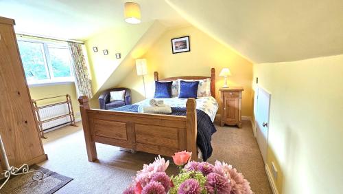 a bedroom with a bed with a teddy bear on it at Beckside - Peaceful Garden House, Dog Friendly in York