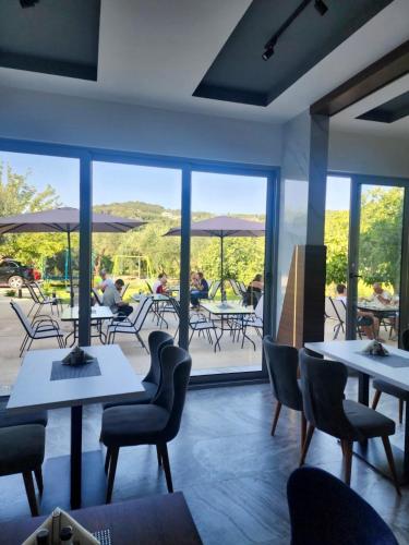 a restaurant with tables and chairs and a patio at Sunrise Apart-Hotel in Ulcinj