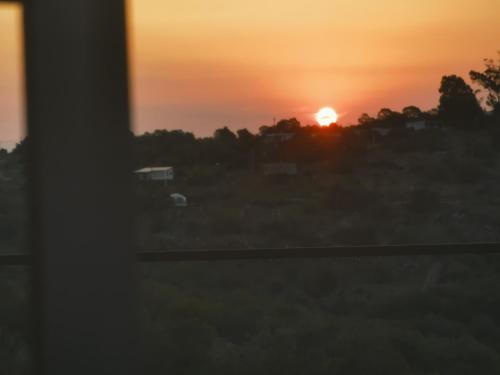 a sunset seen through a window at Rincón de paz in Villa Serrana