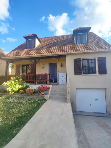 a house with a garage and a roof at Spacious Room for Rent in Le Pecq in Le Pecq
