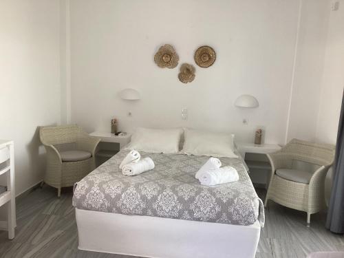 a bedroom with a bed with two towels on it at Nefeli in Drios