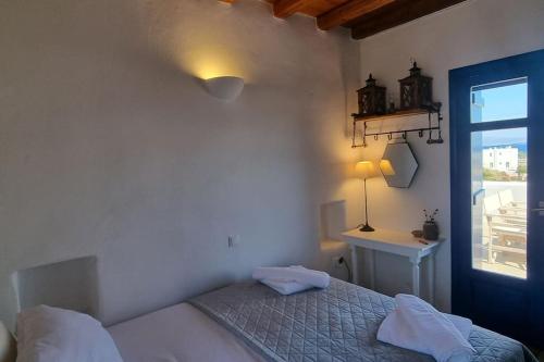 a bedroom with a bed and a window at Villa Kalliopi Ambelas Paros in Ambelas