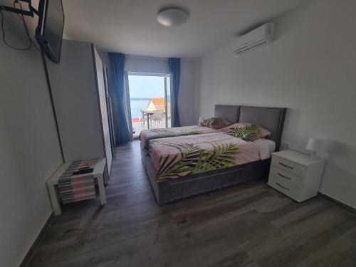 a bedroom with a bed and a view of the ocean at Apartments Elizabeta in Dramalj