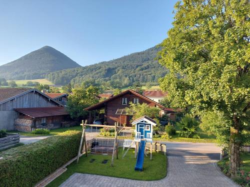 a playground in a village with a mountain in the background at Ferien by Wallners in Bad Feilnbach