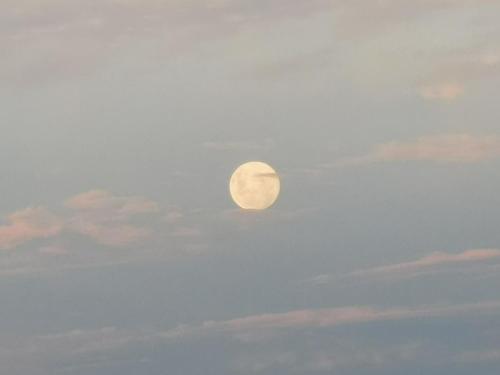 a full moon in the sky with clouds at Rincón de paz in Villa Serrana