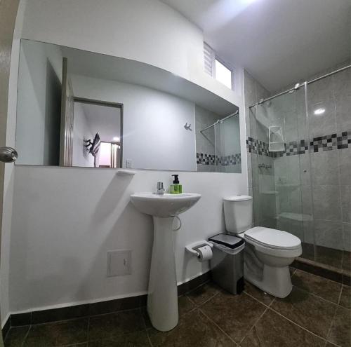 a bathroom with a sink and a toilet and a shower at Ceiba Rooms Hotel in Pereira