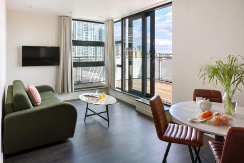 a living room with a couch and a table at Marlin Canary Wharf in London