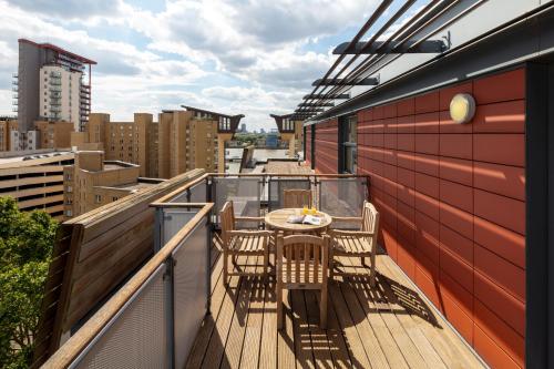 a balcony with a table and chairs on a building at Marlin Canary Wharf in London