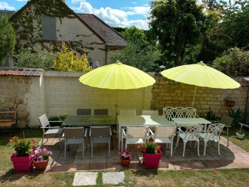 two yellow umbrellas over a table and chairs at Spacious Room for Rent in Le Pecq in Le Pecq