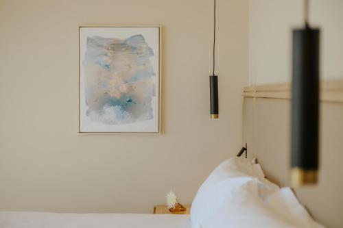 a picture hanging on a wall above a bed at Alion Beach Hotel in Ayia Napa