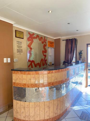 a lobby with a tile counter in a building at The green room in Phalaborwa