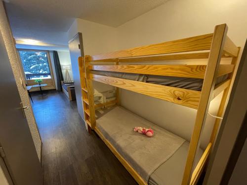 une chambre avec deux lits superposés avec un jouet sur le sol dans l'établissement Bois des Coqs, à Saint-Chaffrey