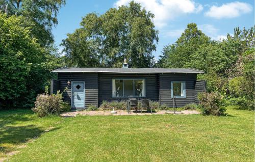 a small cabin in a field with a yard at 3 Bedroom Amazing Home In Gilleleje in Gilleleje