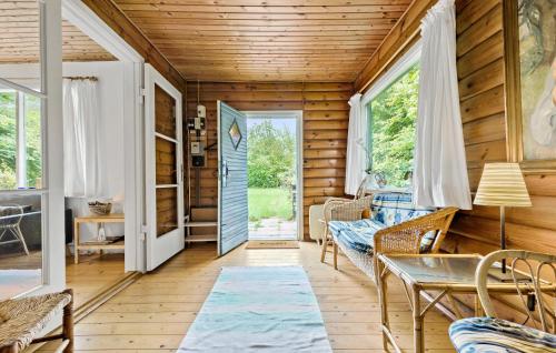 a living room with wooden walls and a wooden floor at 3 Bedroom Amazing Home In Gilleleje in Gilleleje