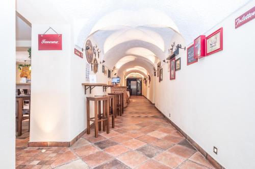 a corridor of a restaurant with a row of tables at Hotel Alte Post in Siegsdorf