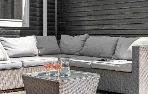 a couch with two wine glasses on a table at 4 Bedroom Stunning Home In Gilleleje in Gilleleje