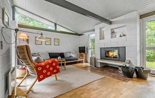 a living room with a couch and a fireplace at 2 Bedroom Lovely Home In Liseleje in Liseleje