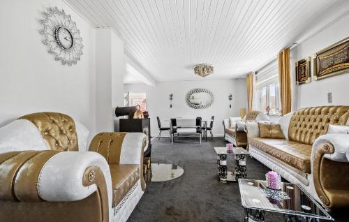 a living room with couches and a table at 3 Bedroom Nice Home In Højby in Højby