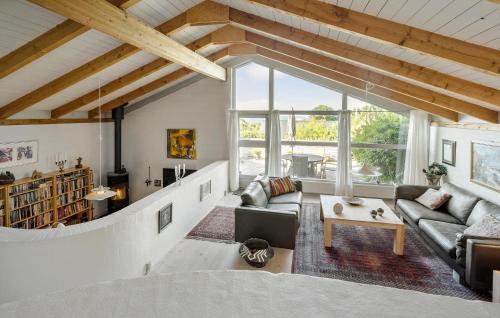 a living room with a couch and a table at 3 Bedroom Beautiful Home In Kalundborg in Kalundborg