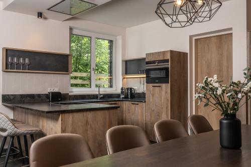 a kitchen with a table and some chairs at 24 by AvenidA - Mountain Hotel in Kaprun