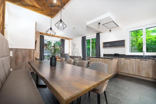 a dining room with a wooden table and chairs at 24 by AvenidA - Mountain Hotel in Kaprun