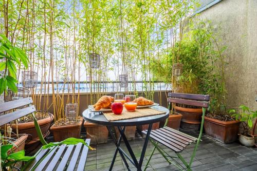 - une table avec une assiette de nourriture sur la terrasse dans l'établissement Superbe duplex Paris-rooftop vue panoramique, à Paris