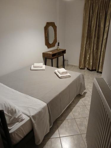 a bedroom with a bed with a sink and a mirror at Pyrgi Village apartment in Pyrgi