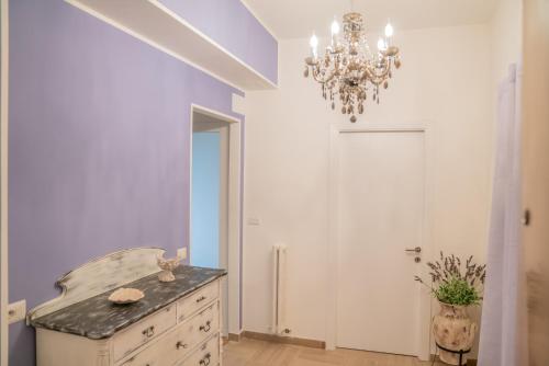 a dining room with a dresser and a chandelier at Vento del Conero in Sirolo