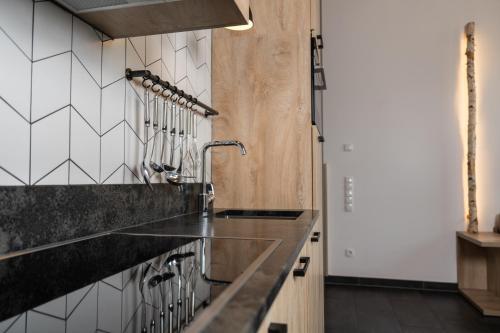 a kitchen with a counter and a sink at 24 by AvenidA - Mountain Hotel in Kaprun