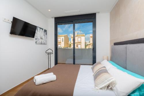 a bedroom with a bed and a large window at Luxurious & Comfy by Fidalsa in El Campello