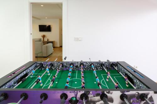 a ping pong table with people playing a game at Luxurious & Comfy by Fidalsa in El Campello