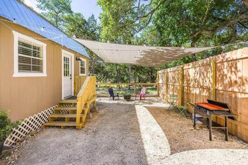 a small yellow house with a porch and a piano at Romantic Driftwood Tiny Casita w Country Views in Driftwood