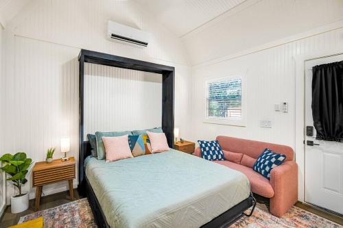 a bedroom with a bed and a couch at Romantic Driftwood Tiny Casita w Country Views in Driftwood